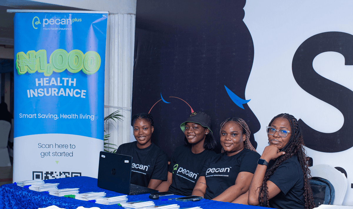 The Pecan team at She Leads Africa with the ₦1,000 Pecan Plus health insurance banner